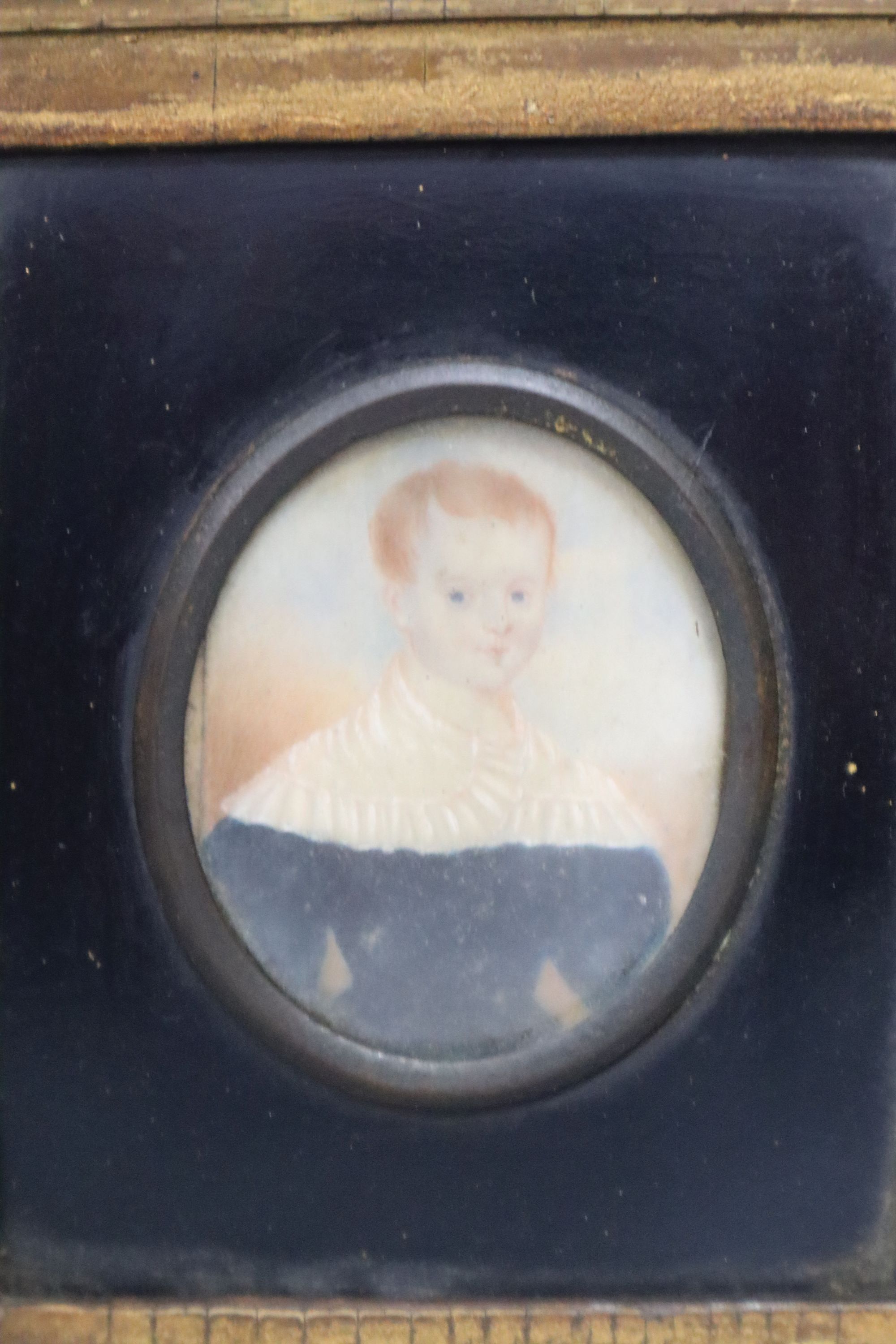 A 19th century oil on ivory miniature of a red-headed youth